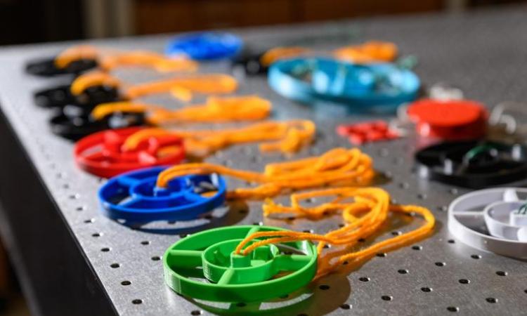 <p>The 3D-Fuge utilizes 3D-printed disks designed to hold small vials of liquid. Simple yarn is used to spin the disks. (Photo: Rob Felt, Georgia Tech).</p>