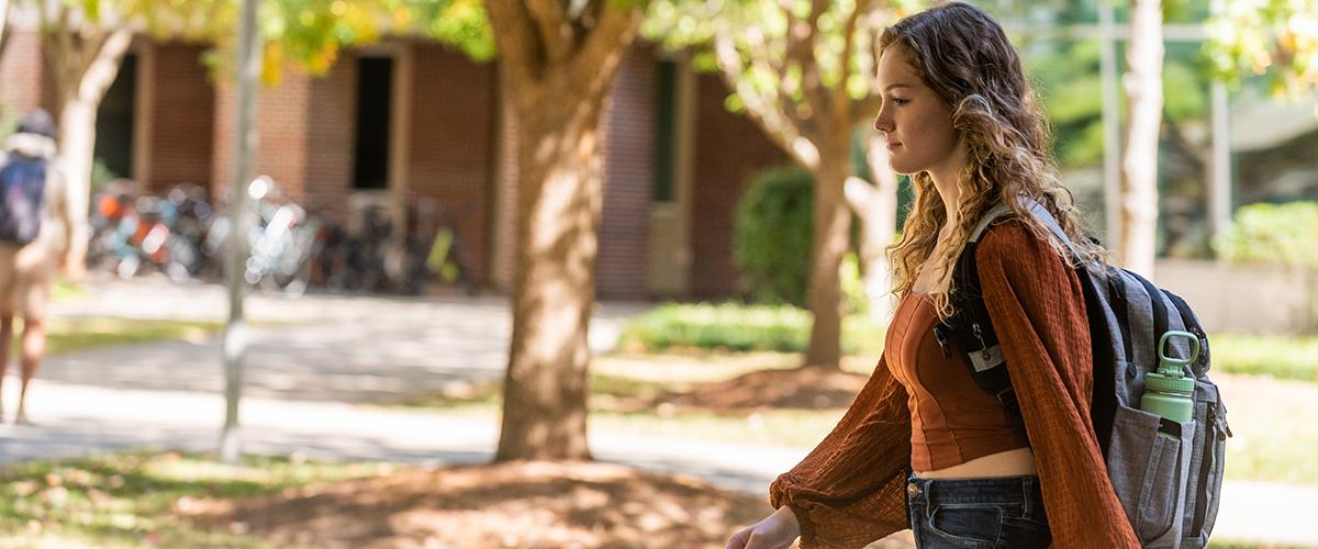 student walking across campus